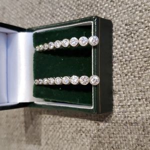 Diamond simulate set in a curve of silver. Not articulated